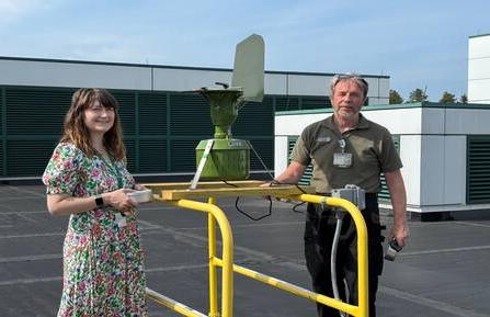 Bruce Spencer and Erin Reigh standing on DHMC roof with pollen counter